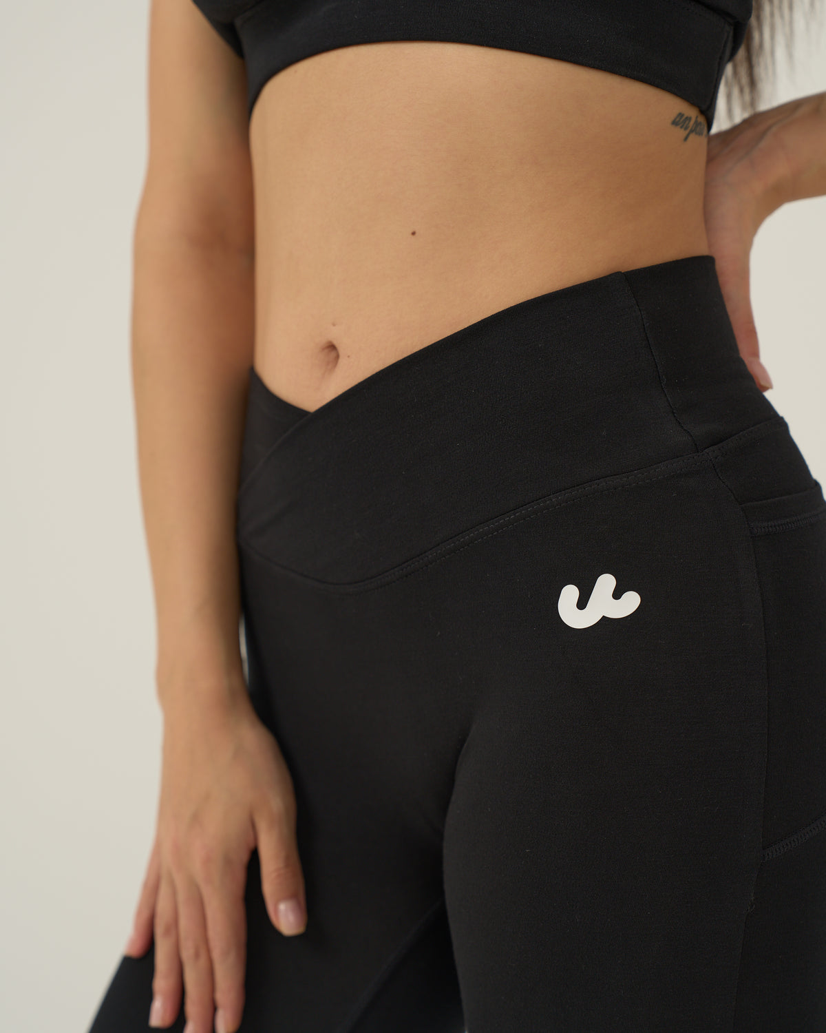 Close up of the crossover high waistband on the Urthlete flare leggings